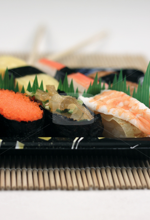 To use this stock image in your creative project, please select the size you need over to the right and click the "Add to Cart" button.
Your downloaded image will come with the Cutcaster watermark removed so don’t worry about the watermark you see on this page. Sushi stock photo, A tray of sushi by Adrin Shamsudin