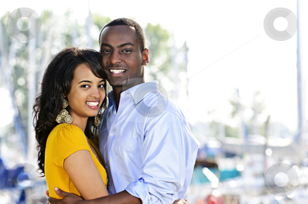 Happy couple embracing Happy couple embracing stock photo, Young romantic couple hugging and standing at harbor by Elena Elisseeva