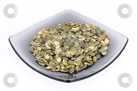Pumpkin seed on glass plate Pumpkin seed on glass plate stock photo, Pumpkin seed on glass plate, isolated on white by Borislav Marinic