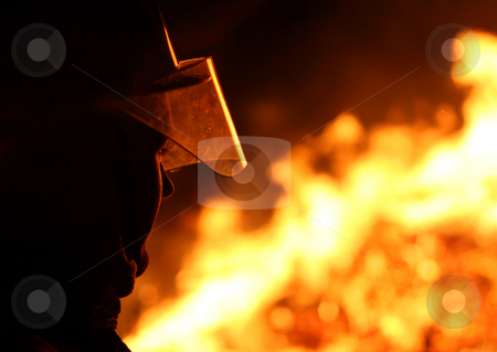 To use this stock image in your creative project, please select the size you need over to the right and click the "Add to Cart" button.
Your downloaded image will come with the Cutcaster watermark removed so don’t worry about the watermark you see on this page. Firefighter stock photo, Silhouette of a firefighter facing a blazing fire by Jon Helgason
