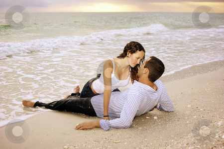 To use this stock image in your creative project, please select the size you need over to the right and click the "Add to Cart" button.
Your downloaded image will come with the Cutcaster watermark removed so don’t worry about the watermark you see on this page. Wet lovers on the beach at sunset stock photo, Two lovers on the beach, he is laying on his back, she is dripping wet between his legs making eye contact with him, they are wet from the ocean waves. In the background the sun is setting. by Stephen Orsillo