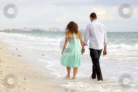 cutcaster-photo-100623832-young-couple-walking-hand-in-hand-on-the-beach-thier-feet-in-the.jpg