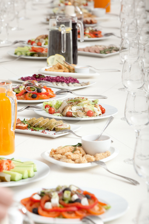 To use this stock image in your creative project, please select the size you need over to the right and click the "Add to Cart" button.
Your downloaded image will come with the Cutcaster watermark removed so don’t worry about the watermark you see on this page. Served restaurant table stock photo, Long served restaurant table with snacks and salads by Ruta Balciunaite