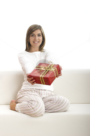 To use this stock image in your creative project, please select the size you need over to the right and click the "Add to Cart" button.
Your downloaded image will come with the Cutcaster watermark removed so don’t worry about the watermark you see on this page. Happy woman with gifts stock photo, Woman in pajama seated on a sofa holding a Christmas gift by ikostudio