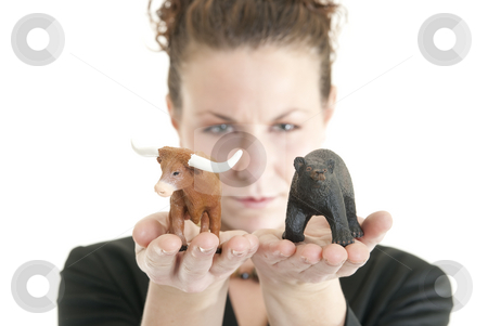 Uncertain market Uncertain market stock photo, Attractive Caucasian female holding a bull and bear symbolizing the stock market. Shallow DOF. Focus on bull and bear. by Christy Thompson
