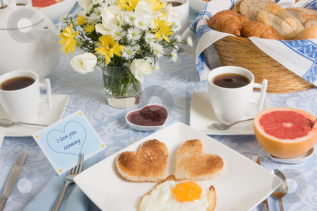 To use this stock image in your creative project, please select the size you need over to the right and click the "Add to Cart" button.
Your downloaded image will come with the Cutcaster watermark removed so don’t worry about the watermark you see on this page. Eggs and hearts stock photo, Mother's day breakfast table with eggs and toast in heart shape by Anneke