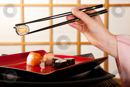 To use this stock image in your creative project, please select the size you need over to the right and click the "Add to Cart" button.
Your downloaded image will come with the Cutcaster watermark removed so don’t worry about the watermark you see on this page. Chopsticks with sushi stock photo, Hands holding sushi with chopsticks in front of a japanese shoji sliding window by Anneke