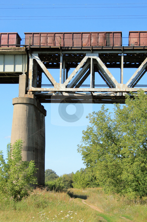 To use this stock image in your creative project, please select the size you need over to the right and click the "Add to Cart" button.
Your downloaded image will come with the Cutcaster watermark removed so don’t worry about the watermark you see on this page. Train on the bridge stock photo, Freight train passing the steel bridge over the river by Jan Remisiewicz