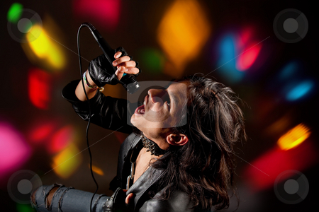 To use this stock image in your creative project, please select the size you need over to the right and click the "Add to Cart" button.
Your downloaded image will come with the Cutcaster watermark removed so don’t worry about the watermark you see on this page. Rock singer stock photo, Young handsome rock singer against a dark background with spot lights by Anneke