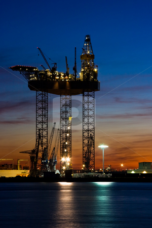To use this stock image in your creative project, please select the size you need over to the right and click the "Add to Cart" button.
Your downloaded image will come with the Cutcaster watermark removed so don’t worry about the watermark you see on this page. Big drilling platform in dock stock photo, Big drilling platform in repair in the harbour at sunset by Colette Planken-Kooij