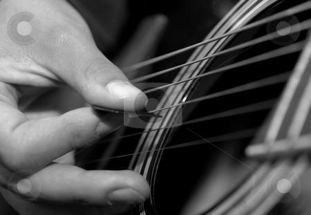To use this stock image in your creative project, please select the size you need over to the right and click the "Add to Cart" button.
Your downloaded image will come with the Cutcaster watermark removed so don’t worry about the watermark you see on this page. Guitar stock photo, Hand picking a black acoustic guitar by P?