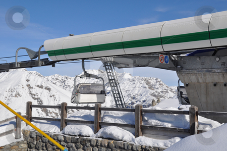 To use this stock image in your creative project, please select the size you need over to the right and click the "Add to Cart" button.
Your downloaded image will come with the Cutcaster watermark removed so don’t worry about the watermark you see on this page. Mountain station of chairlift stock photo, Upper station of modern chairlift for 4 persons with cabin leaving and mountains in the background - shot in Livigno, Italian Alps by Frank G?