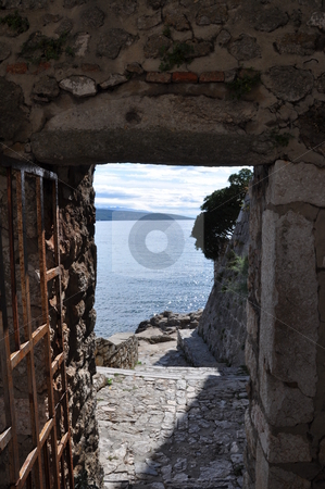 To use this stock image in your creative project, please select the size you need over to the right and click the "Add to Cart" button.
Your downloaded image will come with the Cutcaster watermark removed so don’t worry about the watermark you see on this page. Ocean view stock photo, View through a passage in an old stone wall onto the ocean (Croatia) by Frank G?