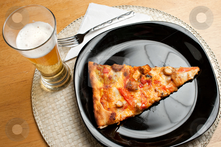 To use this stock image in your creative project, please select the size you need over to the right and click the "Add to Cart" button.
Your downloaded image will come with the Cutcaster watermark removed so don’t worry about the watermark you see on this page. Pizza and Beer stock photo, A single slice of buffalo chicken pizza and a glass of golden lager beer. The perfect weekend take out dinner. by Todd Arena