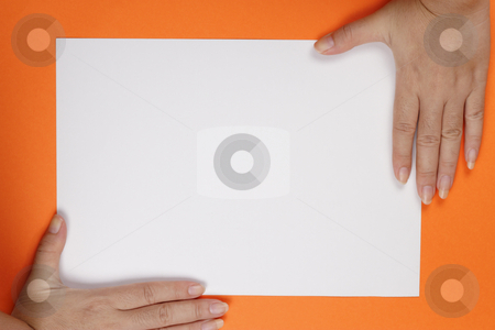 To use this stock image in your creative project, please select the size you need over to the right and click the "Add to Cart" button.
Your downloaded image will come with the Cutcaster watermark removed so don’t worry about the watermark you see on this page. Hand Frame stock photo, A pair of hands on a piece of paper on an orange background by Adrin Shamsudin
