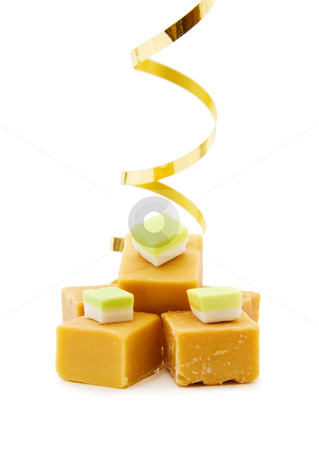 Caramel fudge blocks Caramel fudge blocks stock photo, Joy of food - caramel fudge with golden ribbon. Isolated on white background. by Andreea Chiper