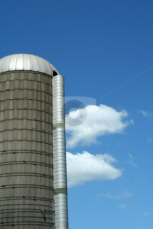 To use this stock image in your creative project, please select the size you need over to the right and click the "Add to Cart" button.
Your downloaded image will come with the Cutcaster watermark removed so don’t worry about the watermark you see on this page. Grain silo stock photo, A grain silo against blue sky by Jim Mills