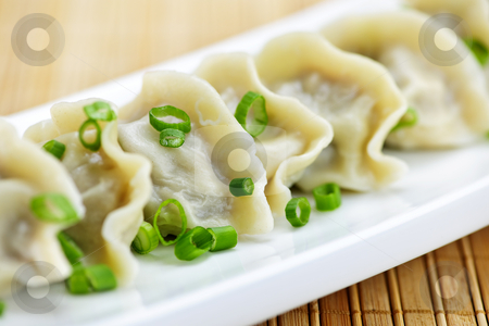 To use this stock image in your creative project, please select the size you need over to the right and click the "Add to Cart" button.
Your downloaded image will come with the Cutcaster watermark removed so don’t worry about the watermark you see on this page. Plate of dumplings stock photo, Plate of cooked chinese dumplings in a row by Elena Elisseeva