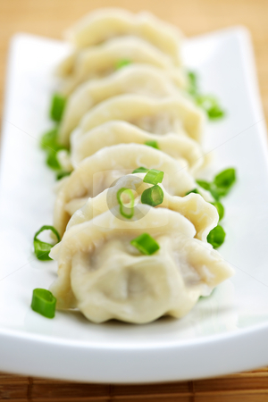 To use this stock image in your creative project, please select the size you need over to the right and click the "Add to Cart" button.
Your downloaded image will come with the Cutcaster watermark removed so don’t worry about the watermark you see on this page. Plate of dumplings stock photo, Plate of cooked chinese dumplings in a row by Elena Elisseeva