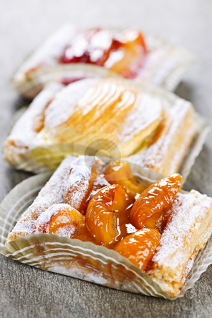 To use this stock image in your creative project, please select the size you need over to the right and click the "Add to Cart" button.
Your downloaded image will come with the Cutcaster watermark removed so don’t worry about the watermark you see on this page. Pieces of fruit strudel stock photo, Closeup on slices of flaky fruit strudel desserts by Elena Elisseeva