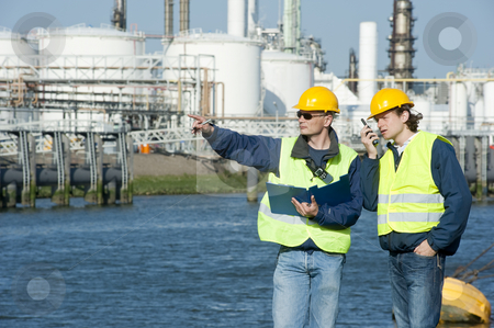 Petrochemical Engineers Petrochemical Engineers stock photo, Two petrochemical engineers discussing a project outdoors by Corepics VOF