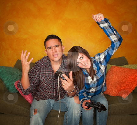 To use this stock image in your creative project, please select the size you need over to the right and click the "Add to Cart" button.
Your downloaded image will come with the Cutcaster watermark removed so don’t worry about the watermark you see on this page. Hispanic Man and Girl Playing Video game stock photo, Attractive Hispanic Man and Girl Playing a Video Game with Handheld Controllers by Scott Griessel