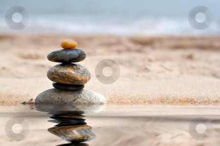 To use this stock image in your creative project, please select the size you need over to the right and click the "Add to Cart" button.
Your downloaded image will come with the Cutcaster watermark removed so don’t worry about the watermark you see on this page. Stacked Zen Rocks Reflection stock photo, A pile of round smooth zen like stones stacked in the sand at the beach with a mirror reflection from a pool of water. by Todd Arena