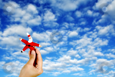 To use this stock image in your creative project, please select the size you need over to the right and click the "Add to Cart" button.
Your downloaded image will come with the Cutcaster watermark removed so don’t worry about the watermark you see on this page. Santa Claus stock photo, Holding up Santa figure against blue sky and layers of clouds by Suprijono Suharjoto