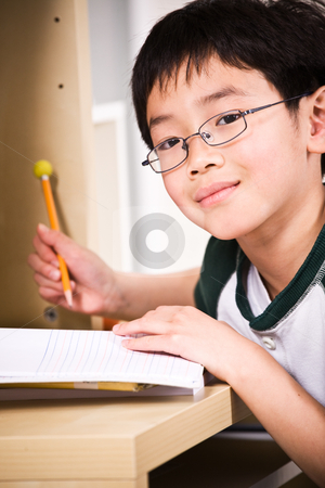 Studying kid Studying kid stock photo, A shot of an asian kid studying at home by Suprijono Suharjoto