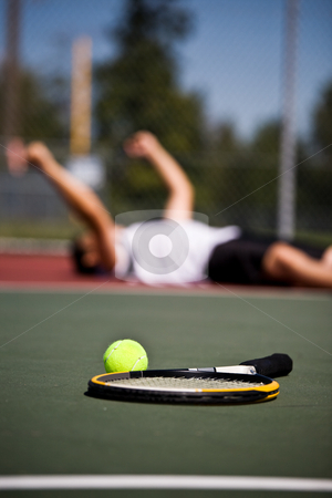 Happy tennis player after winning Happy tennis player after winning stock photo, A happy young tennis player lying down on the court after winning by Suprijono Suharjoto