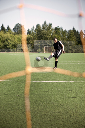 To use this stock image in your creative project, please select the size you need over to the right and click the "Add to Cart" button.
Your downloaded image will come with the Cutcaster watermark removed so don’t worry about the watermark you see on this page. Hispanic soccer or football player kicking a ball stock photo, A shot of a hispanic soccer or football player kicking a ball by Suprijono Suharjoto