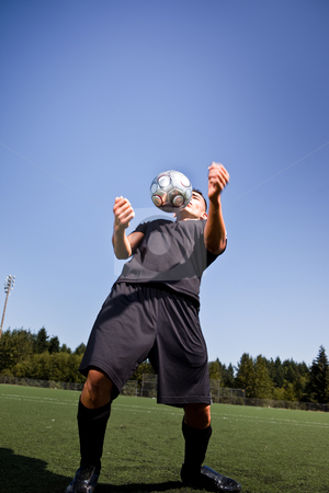 Hispanic soccer or football player with soccer ball Hispanic soccer or football player with soccer ball stock photo, A shot of a hispanic soccer or football player controlling the ball with his chest by Suprijono Suharjoto