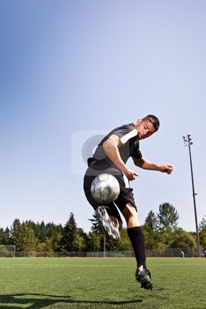 Hispanic soccer or football player kicking a ball Hispanic soccer or football player kicking a ball stock photo, A shot of a hispanic soccer or football player kicking a ball by Suprijono Suharjoto