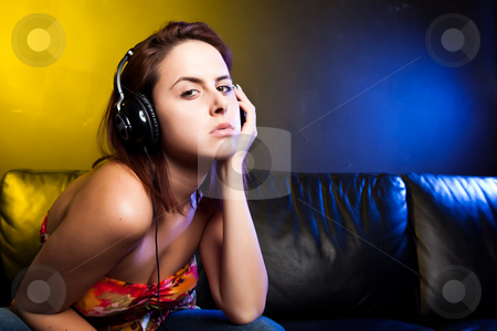 To use this stock image in your creative project, please select the size you need over to the right and click the "Add to Cart" button.
Your downloaded image will come with the Cutcaster watermark removed so don’t worry about the watermark you see on this page. Beautiful woman with headphones stock photo, A shot of a beautiful caucasian woman sitting on the sofa listening music with headphones by Suprijono Suharjoto