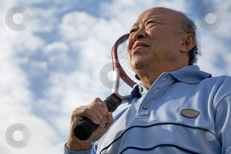 Senior tennis player Senior tennis player stock photo, A shot of a senior asian man holding a tennis racquet by Suprijono Suharjoto