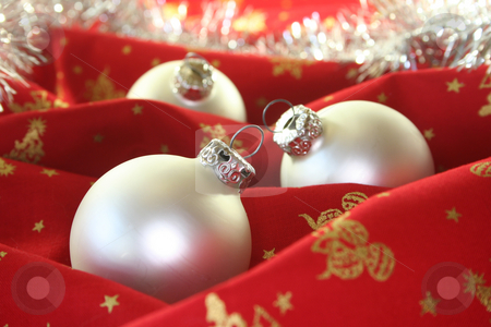To use this stock image in your creative project, please select the size you need over to the right and click the "Add to Cart" button.
Your downloaded image will come with the Cutcaster watermark removed so don’t worry about the watermark you see on this page. Christmas balls stock photo, Three silver Christmas balls and tinsel chain lie on red fabric by Marén Wischnewski