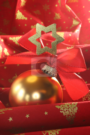 To use this stock image in your creative project, please select the size you need over to the right and click the "Add to Cart" button.
Your downloaded image will come with the Cutcaster watermark removed so don’t worry about the watermark you see on this page. Christmas ball stock photo, A gold Christmas ball with ribbon and star on red fabric by Marén Wischnewski