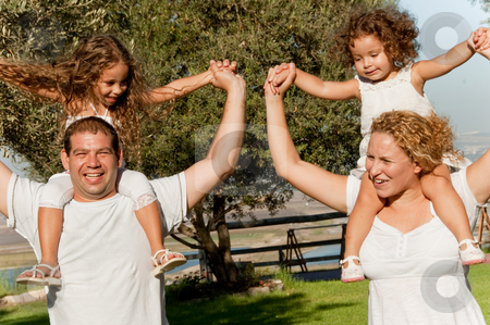 Family lifestyle portrait Family lifestyle portrait stock photo, Happy family lifestyle portrait of a mum and dad with their two kids having fun by Get4net