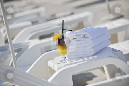 To use this stock image in your creative project, please select the size you need over to the right and click the "Add to Cart" button.
Your downloaded image will come with the Cutcaster watermark removed so don’t worry about the watermark you see on this page. Coctail drink stock photo, Coctail dring with orange att sunny day on swimming pool side with white towel decoraton by Benis Arapovic