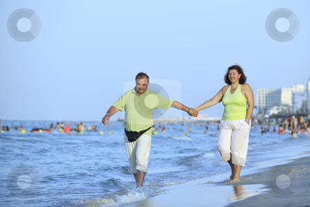 Happy seniors couple on beach Happy seniors couple on beach stock photo, Happy senior mature elderly people couple have romantic time on beach at sunset by Benis Arapovic