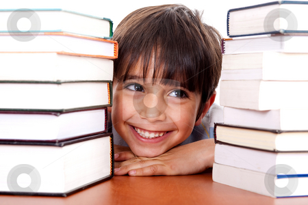 Young kid relaxing between pile of books Young kid relaxing between pile of books stock photo, Young kid relaxing between pile of books and looking away by Get4net