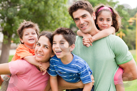 Kids enjoying piggyback ride Kids enjoying piggyback ride stock photo, Parents piggyback their young children in the summer park, outdoors by Get4net