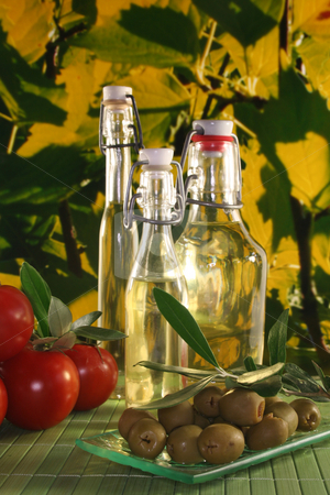 Olive oil Olive oil stock photo, Olive oil with olive branch and fresh olives and tomatoes by Marén Wischnewski
