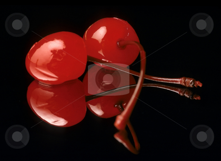 Cherries Cherries stock photo, Two maraschino cherries on a black reflective background by Christian Delbert