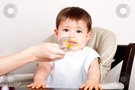 Baby dislikes food Baby dislikes food stock photo, Cute baby infant boy girl expresses dislike disgust for food fed by spoon. by Paul Hakimata