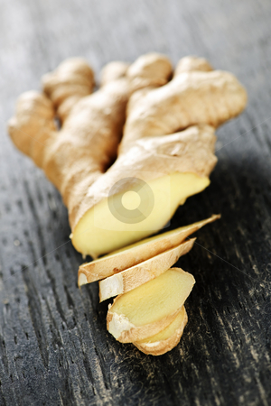 Ginger root Ginger root stock photo, Close up of sliced fresh ginger root spice on wooden table by Elena Elisseeva
