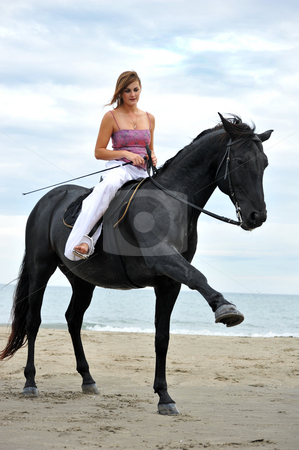 To use this stock image in your creative project, please select the size you need over to the right and click the "Add to Cart" button.
Your downloaded image will come with the Cutcaster watermark removed so don’t worry about the watermark you see on this page. Girl and horse on the beach stock photo, Beautiful black stallion on the beach with young woman by Bonzami Emmanuelle