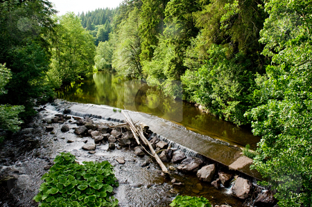 To use this stock image in your creative project, please select the size you need over to the right and click the "Add to Cart" button.
Your downloaded image will come with the Cutcaster watermark removed so don’t worry about the watermark you see on this page. Water weir stock photo, Calm river in the forest plashes over a weir by Herb Allgaier