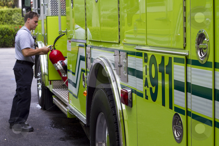 Firefighter at truck at fire Firefighter at truck at fire stock photo, by David Pino