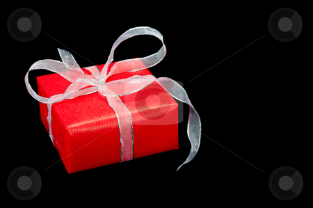 To use this stock image in your creative project, please select the size you need over to the right and click the "Add to Cart" button.
Your downloaded image will come with the Cutcaster watermark removed so don’t worry about the watermark you see on this page. Red and Silver Xmas Gift Box on Black stock photo, Single red and silver Xmas gift box on a black background by Timothy Hodgkinson